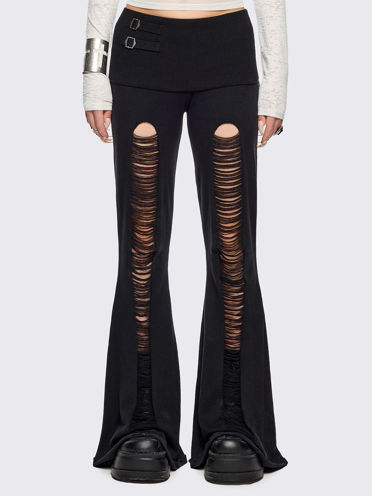 Black distressed flare pants with ribbed waistband.