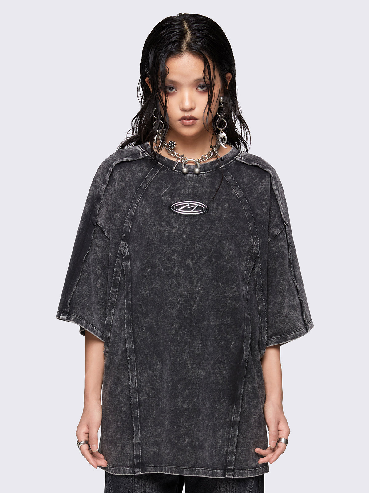 Grey distressed wash t-shirt with exposed seams details, metallic signature patch detail on front and oversized fit.