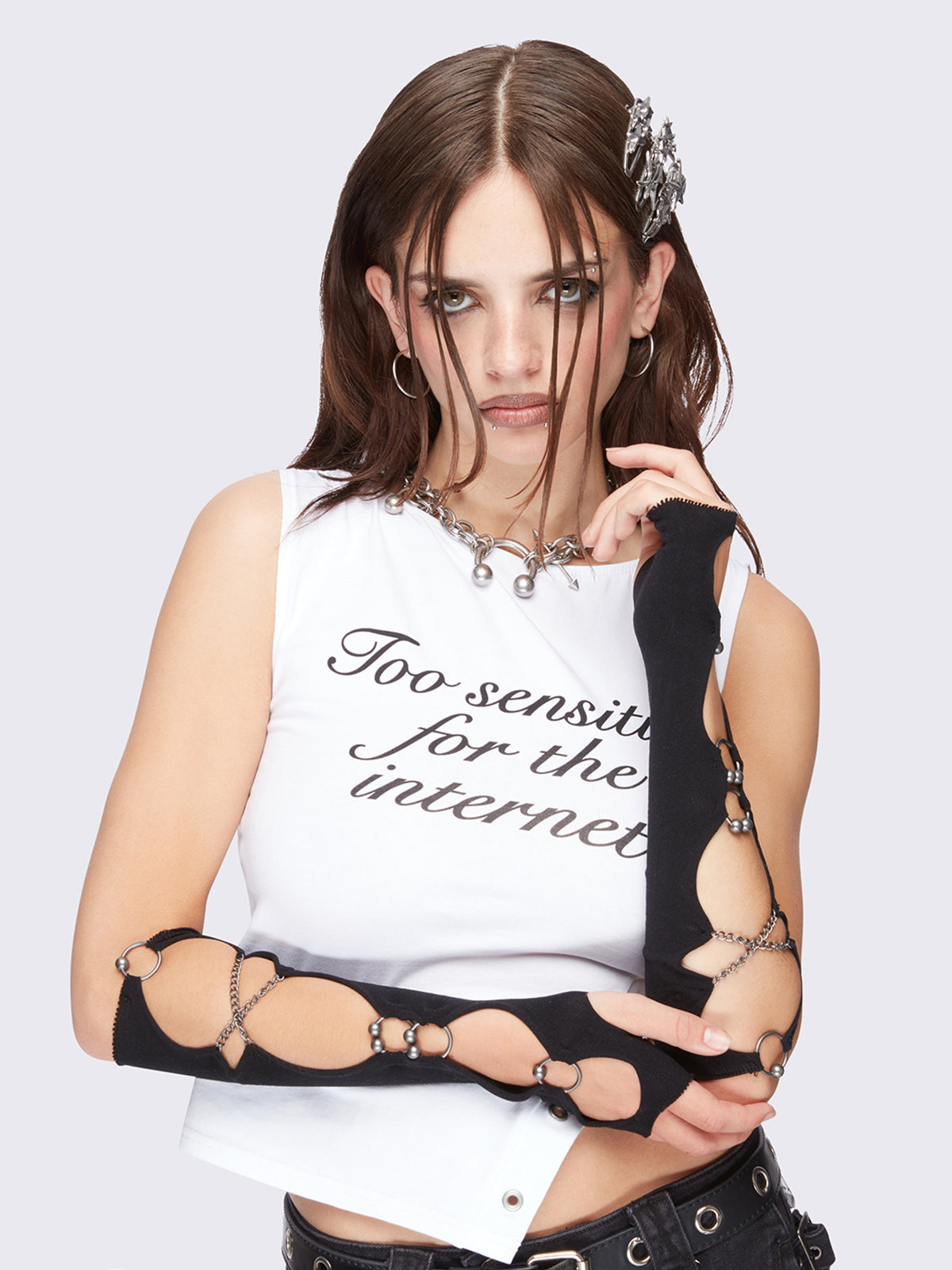 Black cut-out arm warmers with piercing and chain details.