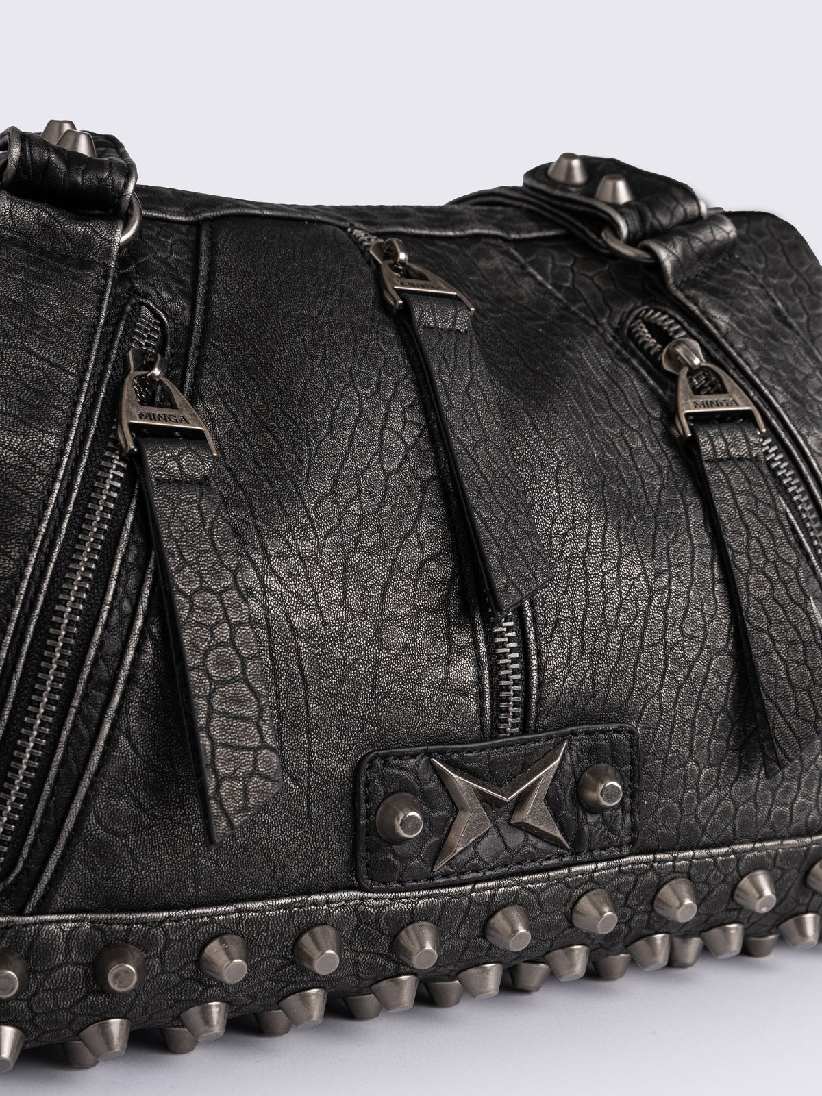 Black faux leather shoulder bag featuring stud and metal hardware details.