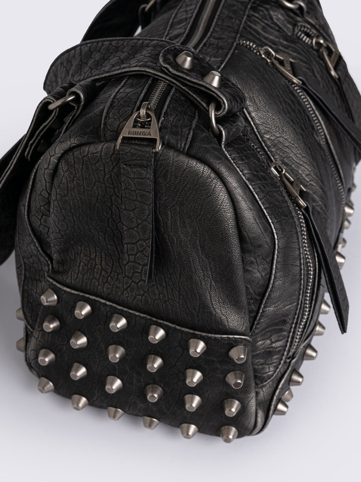 Black faux leather shoulder bag featuring stud and metal hardware details.