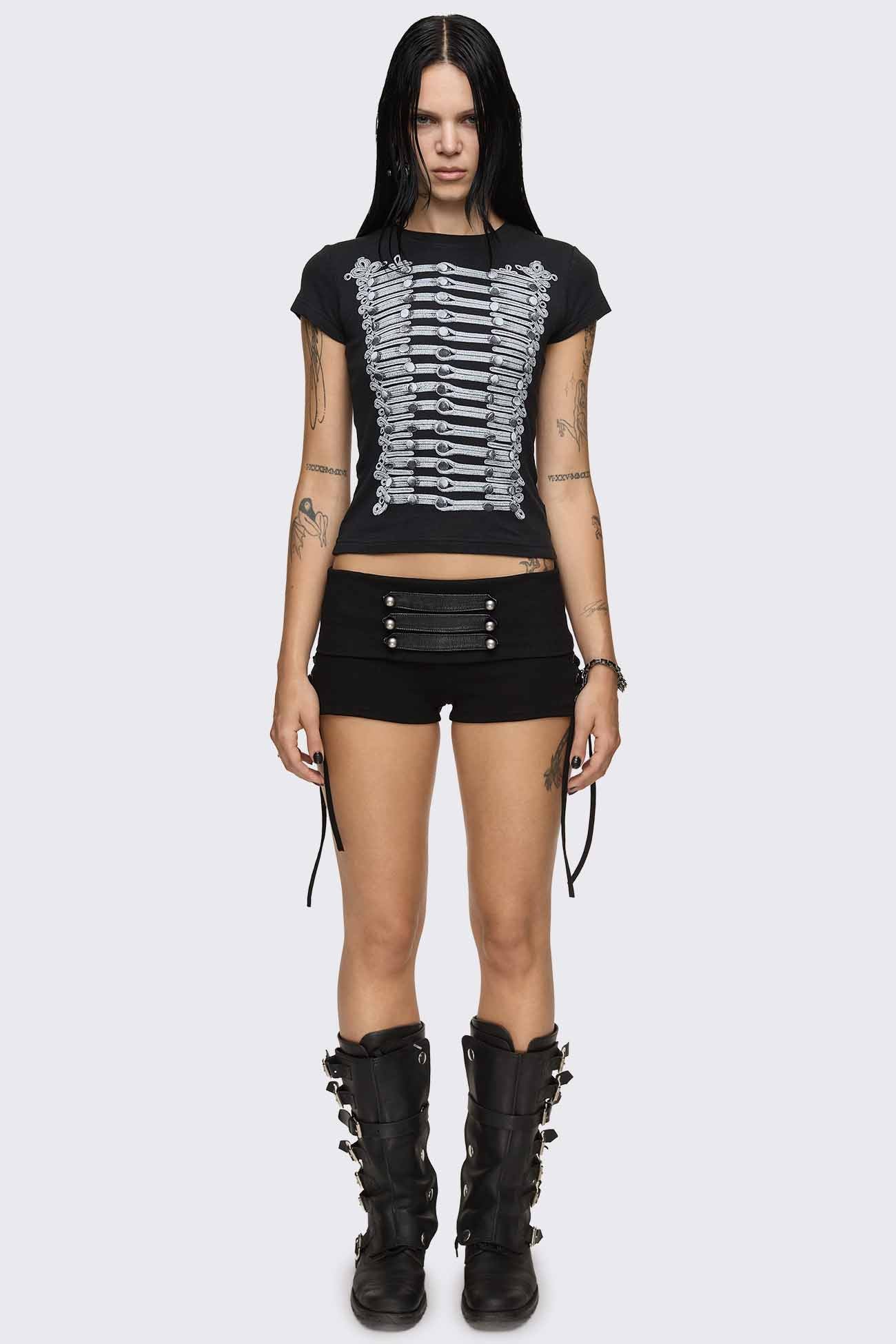Black hot pants with lace-up sides, faux leather straps, silver dome buttons and a wide fold-over waistband.