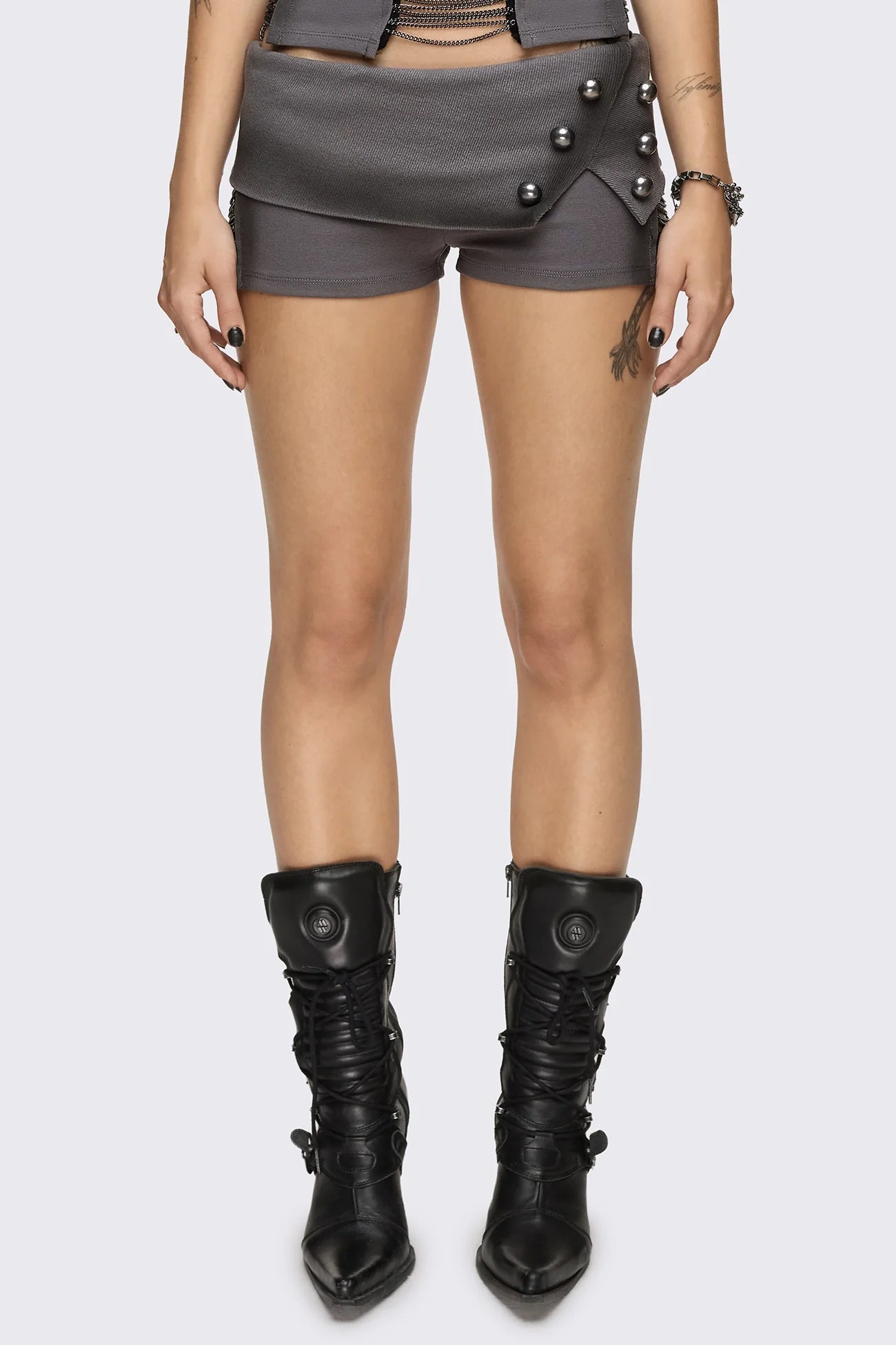 Grey washed jersey hot pants with side cutouts, silver chains and a studded fold-over low rise waistband.