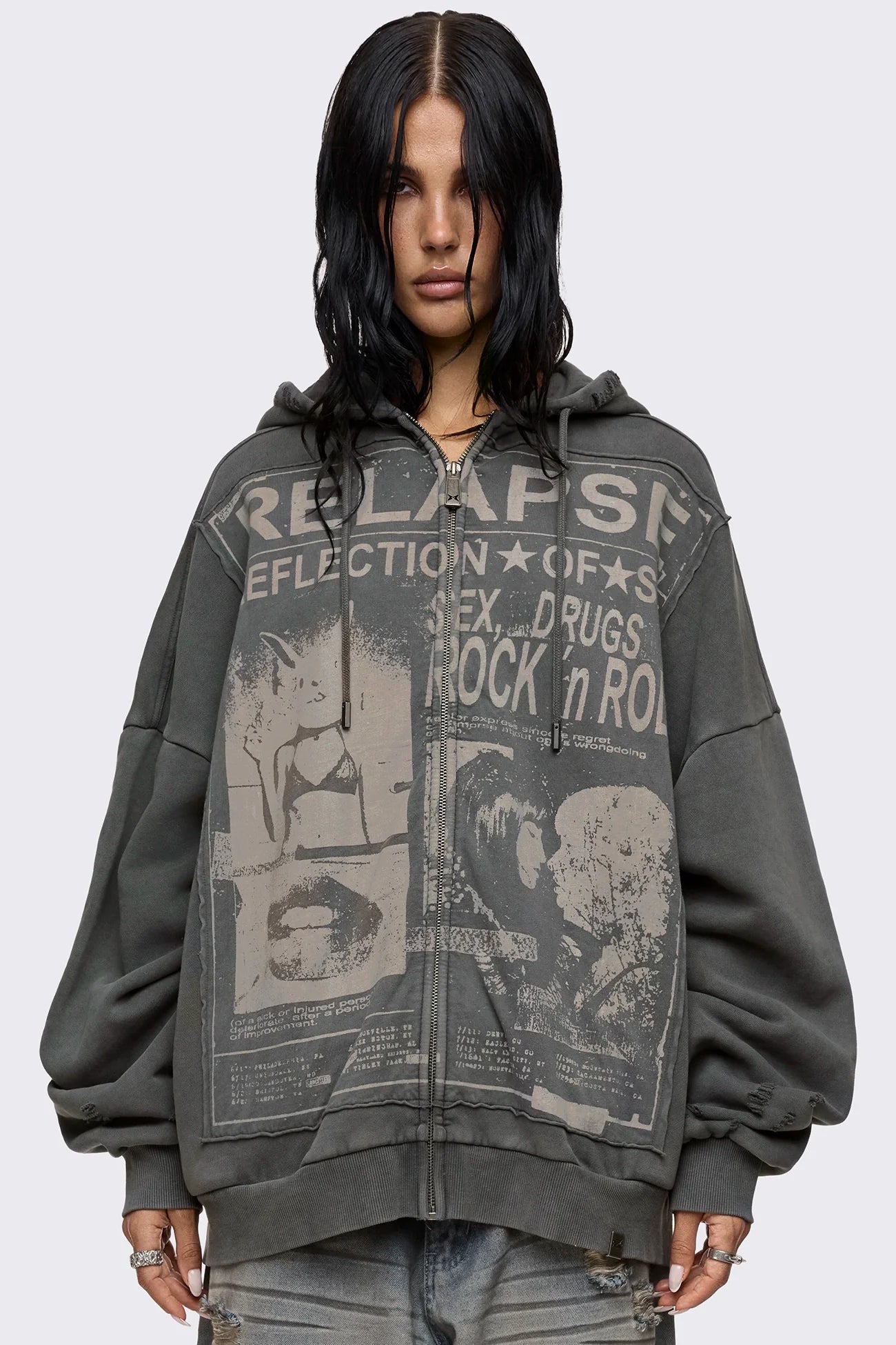 Grey washed zip up hoodie with Relapse graphic print, distressed details and oversized fit on model.