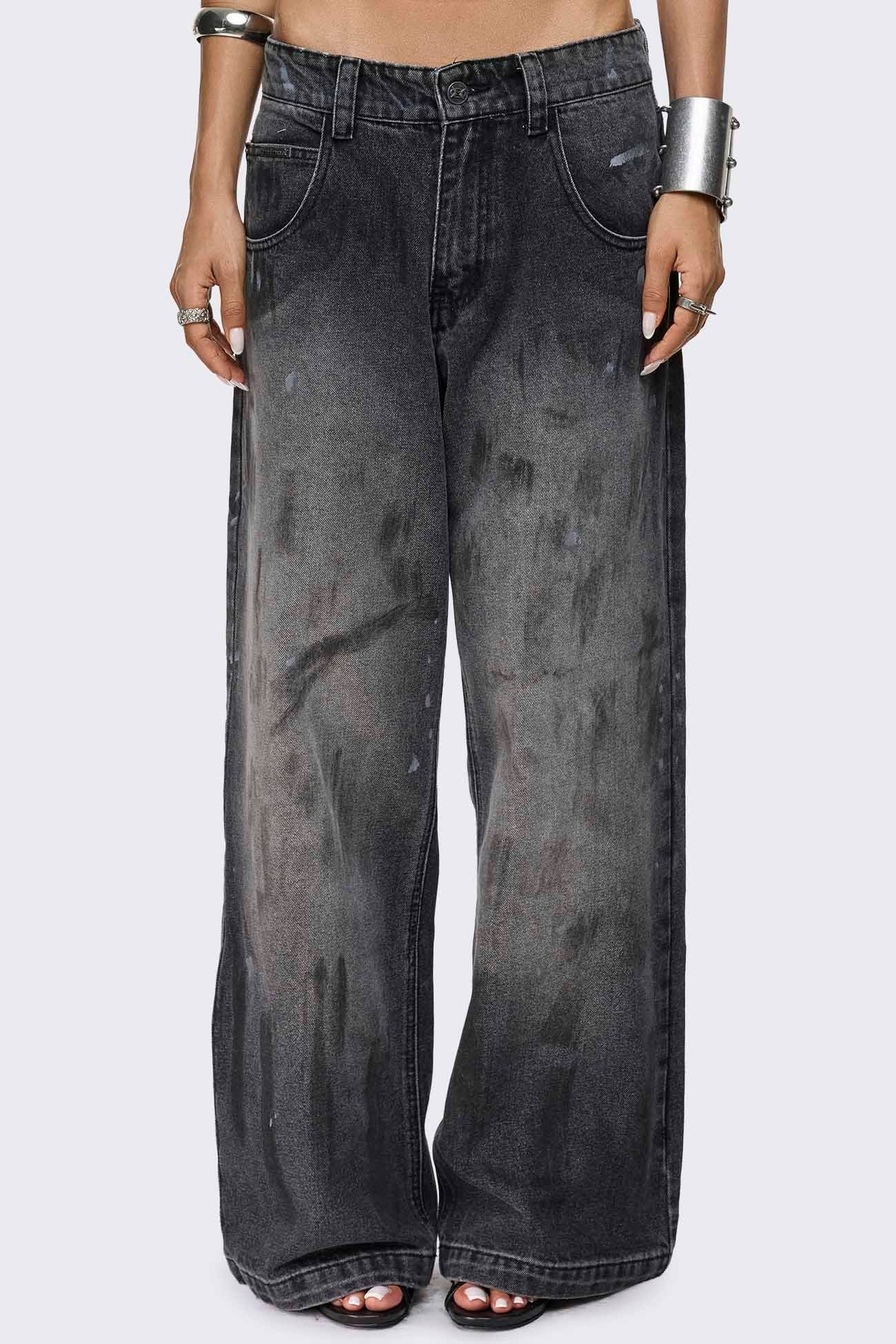 Faded black baggy jeans with paint splatter detail, distressed finish, low-rise waist and straight leg fit.