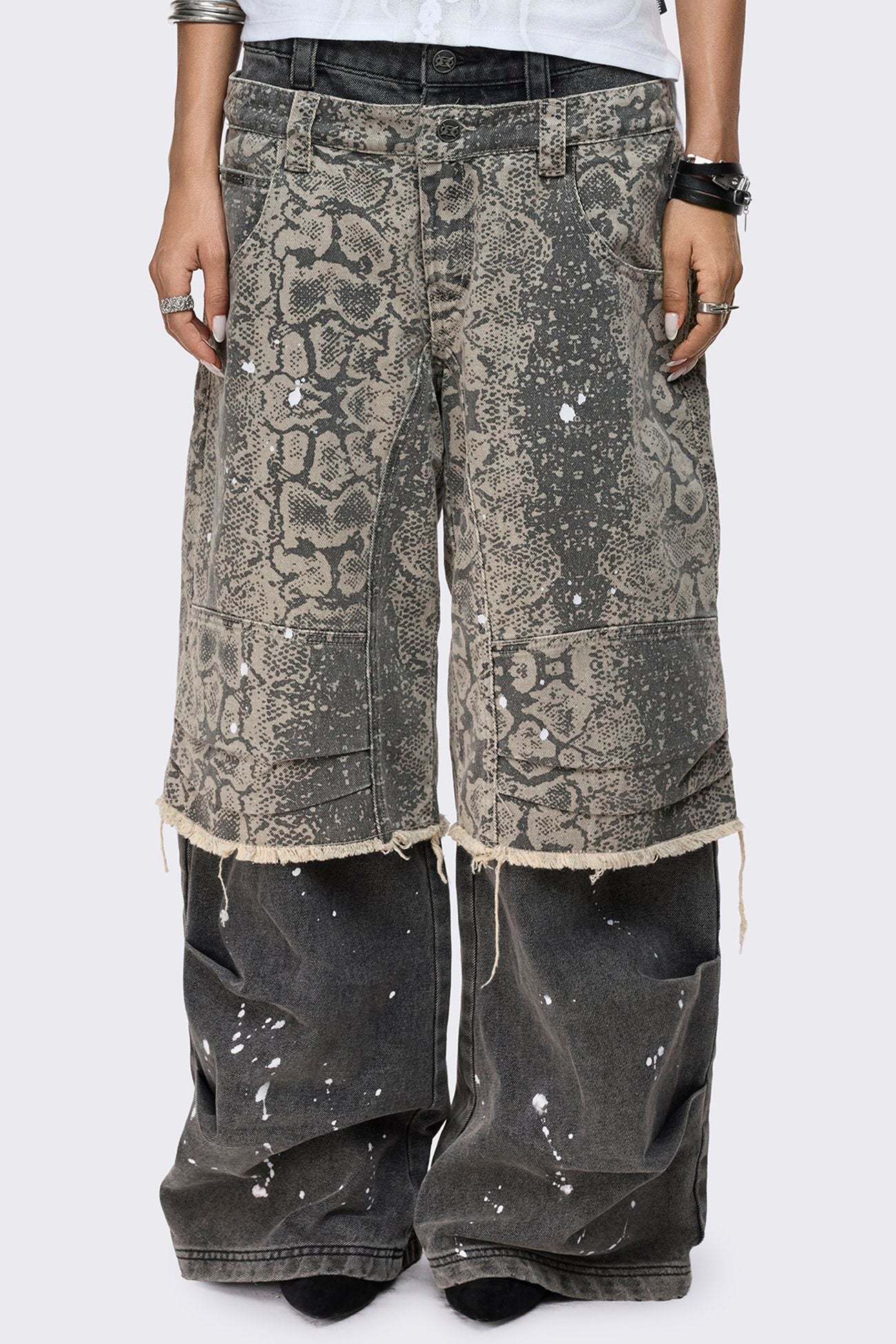 Grey snake print layered baggy jeans with paint splatter, low rise waist, wide leg fit and frayed raw hem.