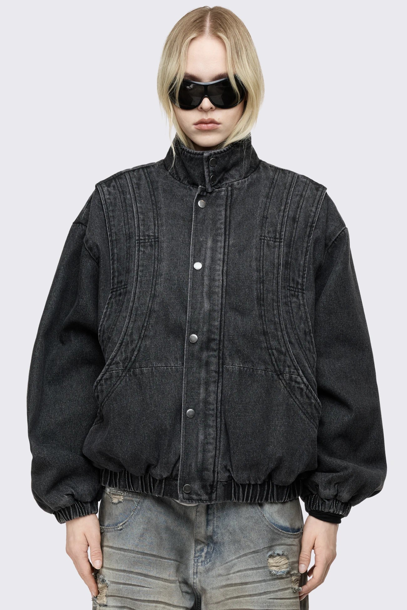 Black washed denim bomber jacket with layered detail, high collar, snap buttons, side pockets and an oversized fit.