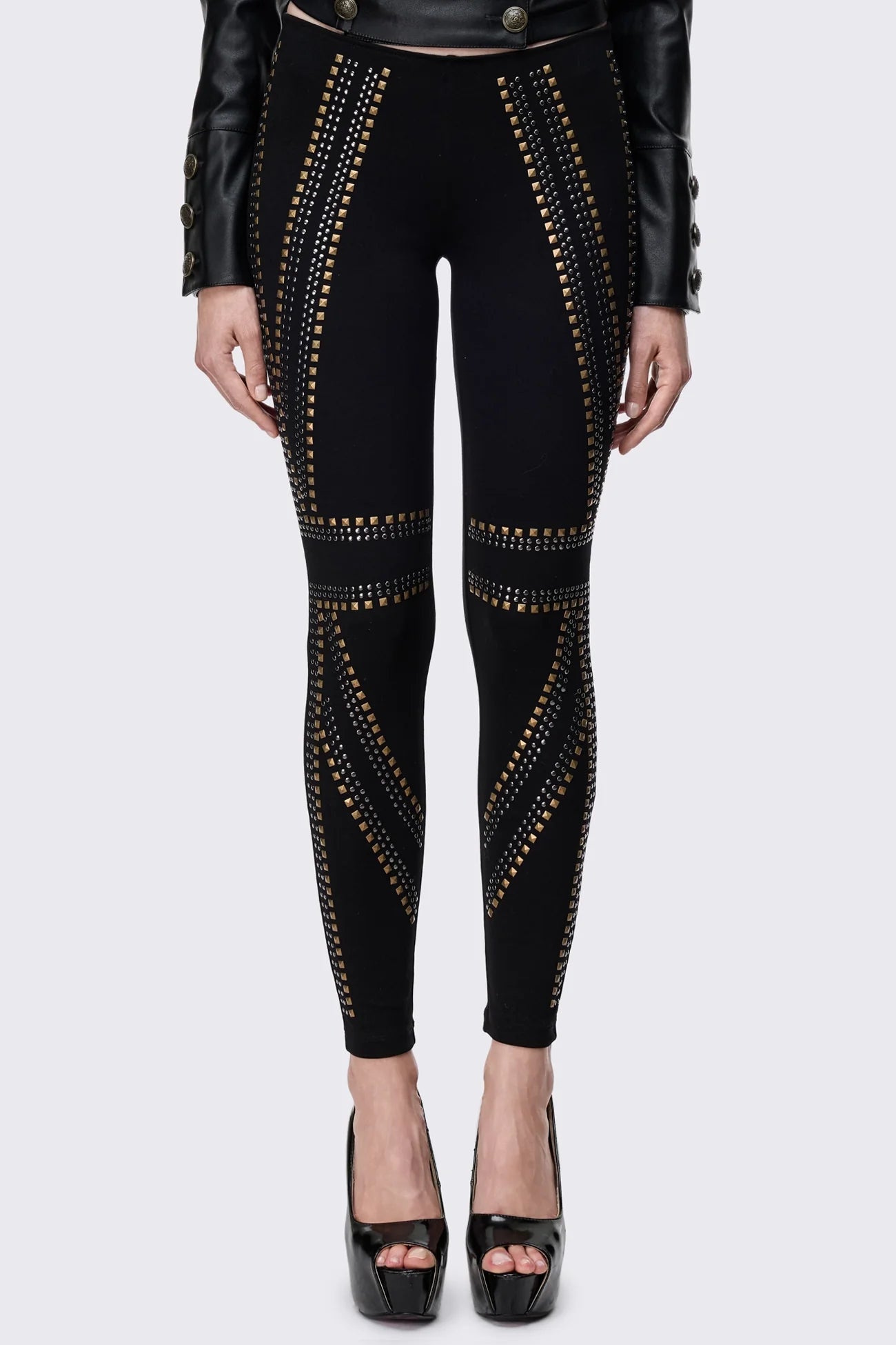Black slim fit leggings with silver and antique-brass stud panels on front and legs.