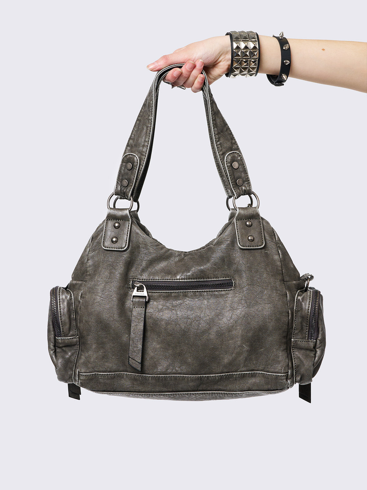 Grey washed faux leather shoulder bag with studded cross patches, spikes and chains accents. Multiple pockets and grunge-style.