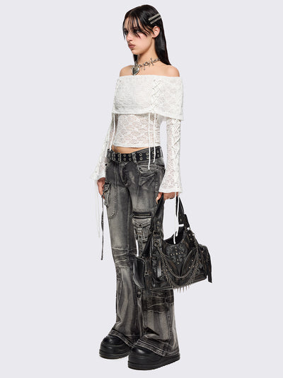 Off shoulder top in white lace construction. Bardot fold-over neck, lace up details and long flared sleeves.