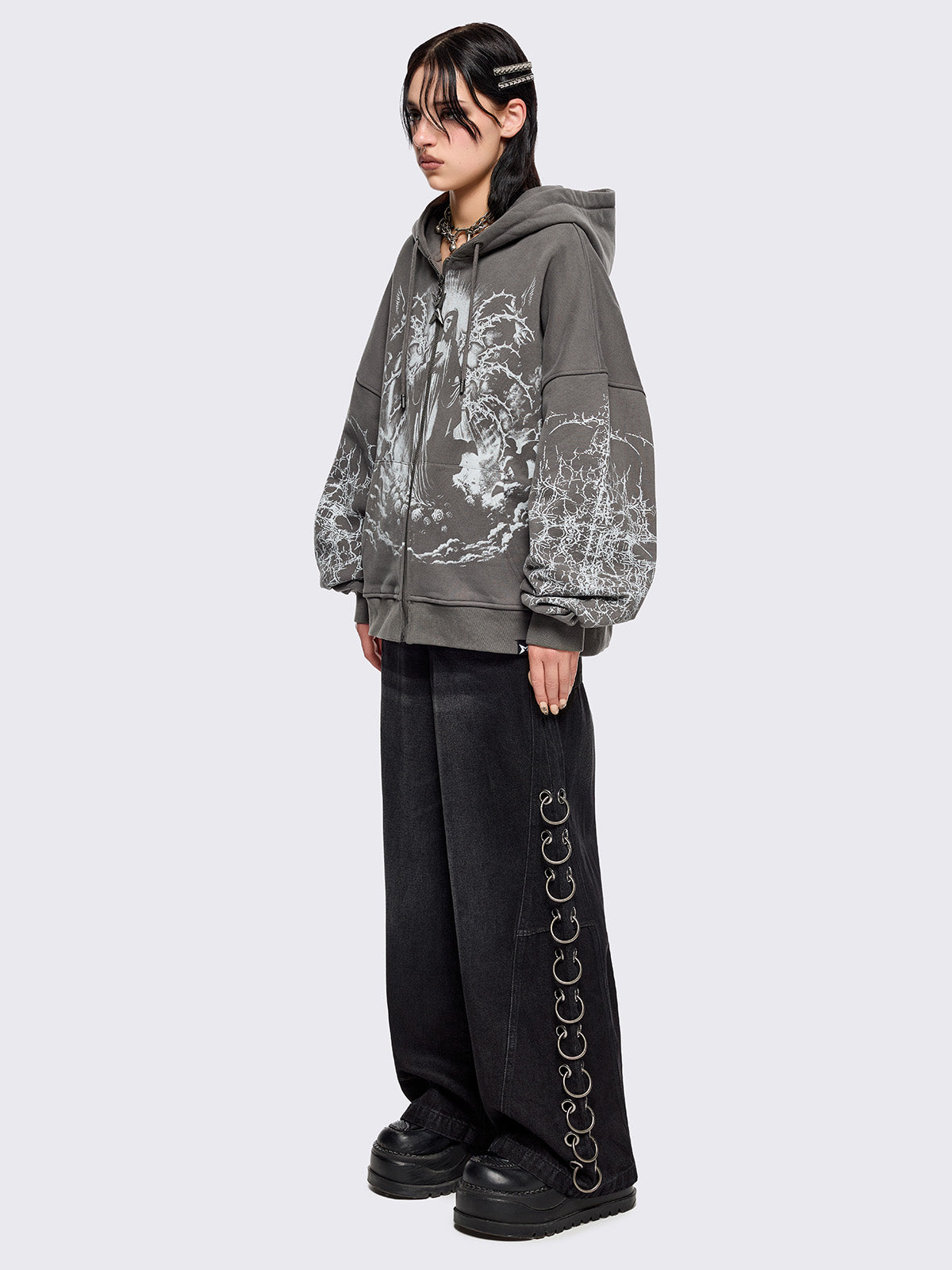 Grey zip up hoodie jacket featuring a sacred figure graphic on front and thorn sleeve prints.