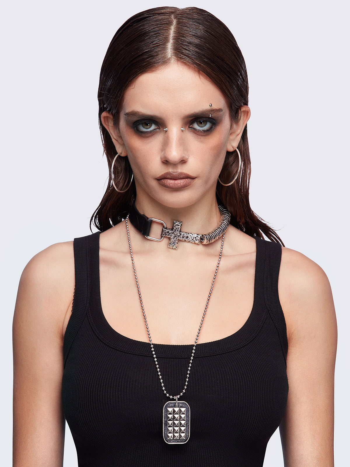 Set of 2 necklaces: Black faux leather choker with a cross buckle detail and a long ball chain necklace with dog-tag style pendant.