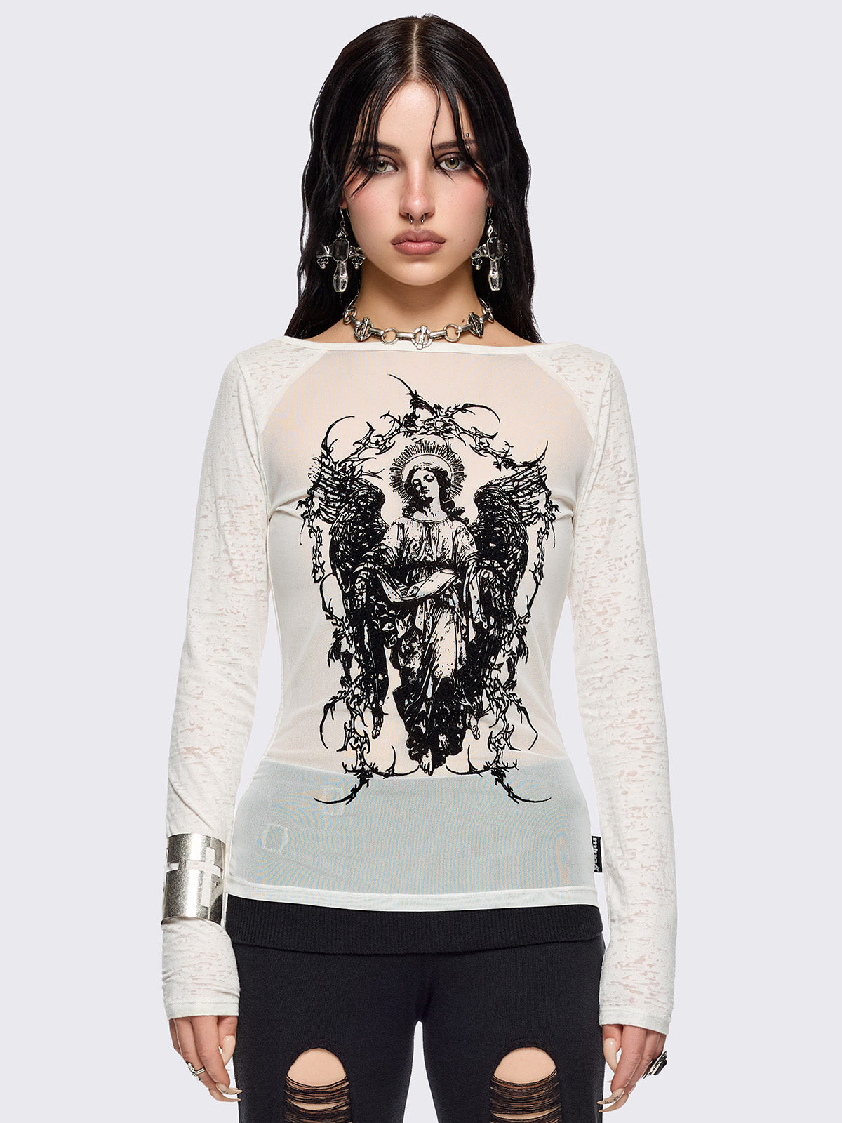 White semi-sheer long sleeve top with a black sacred figure graphic front print and mesh contrast.