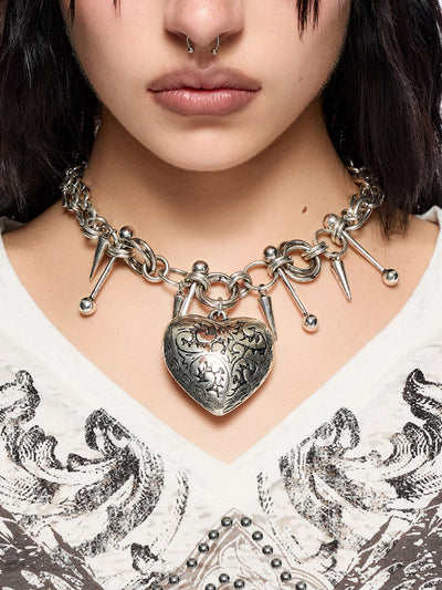 Silver chunky charm necklace with 3D heart pendant and bold metal piercing and spike details.