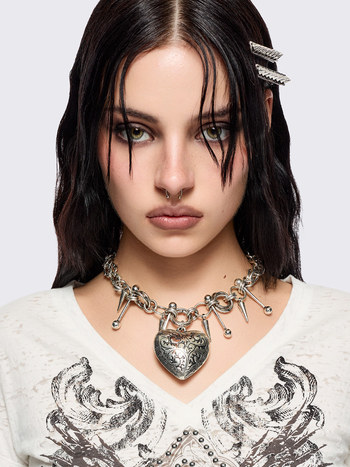 Silver chunky charm necklace with 3D heart pendant and bold metal piercing and spike details.
