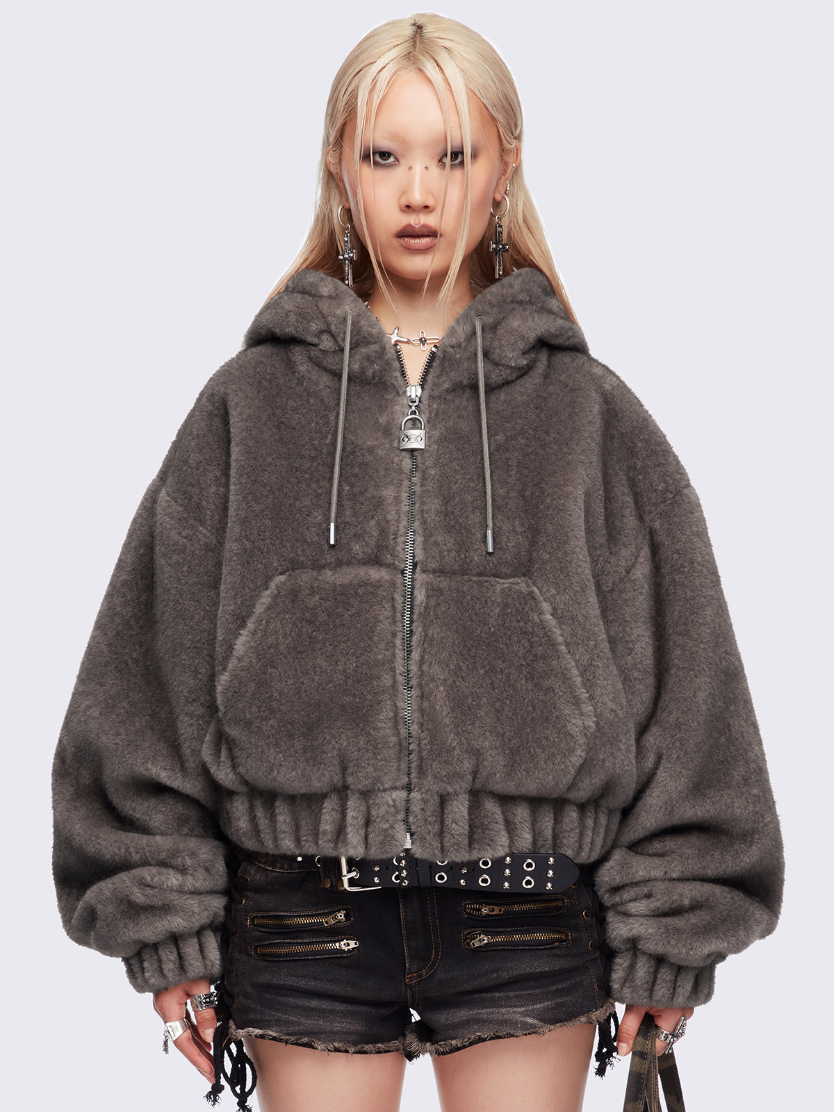 Brown oversize faux fur jacket with cat ear hood with piercing details.