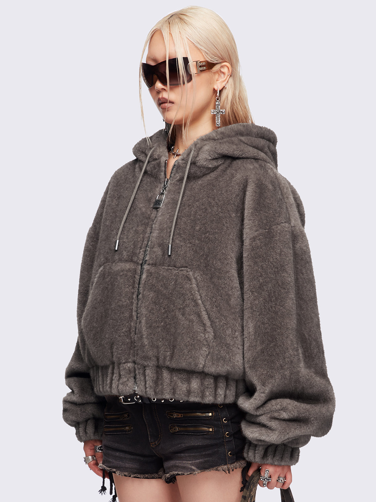 Brown oversize faux fur jacket with cat ear hood with piercing details.