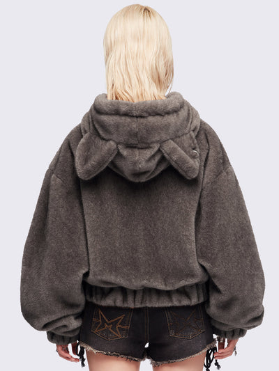 Brown oversize faux fur jacket with cat ear hood with piercing details.
