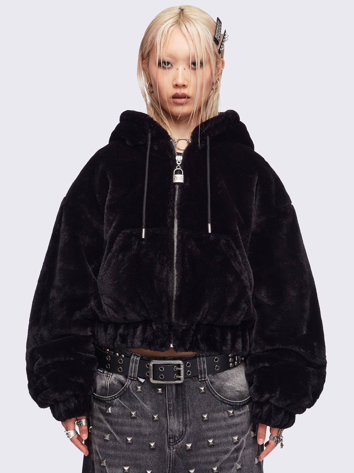 Black oversize faux fur jacket with cat ear hood with piercing details.