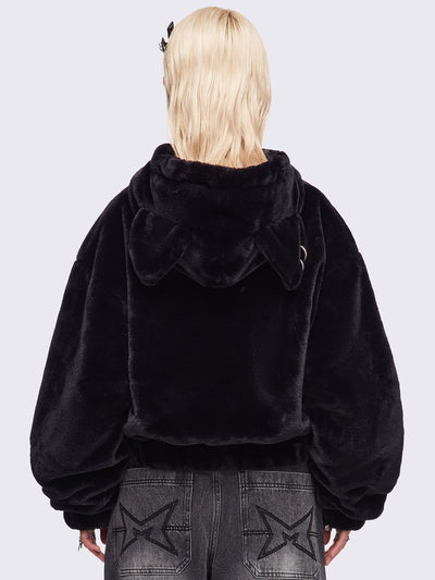 Black oversize faux fur jacket with cat ear hood with piercing details.