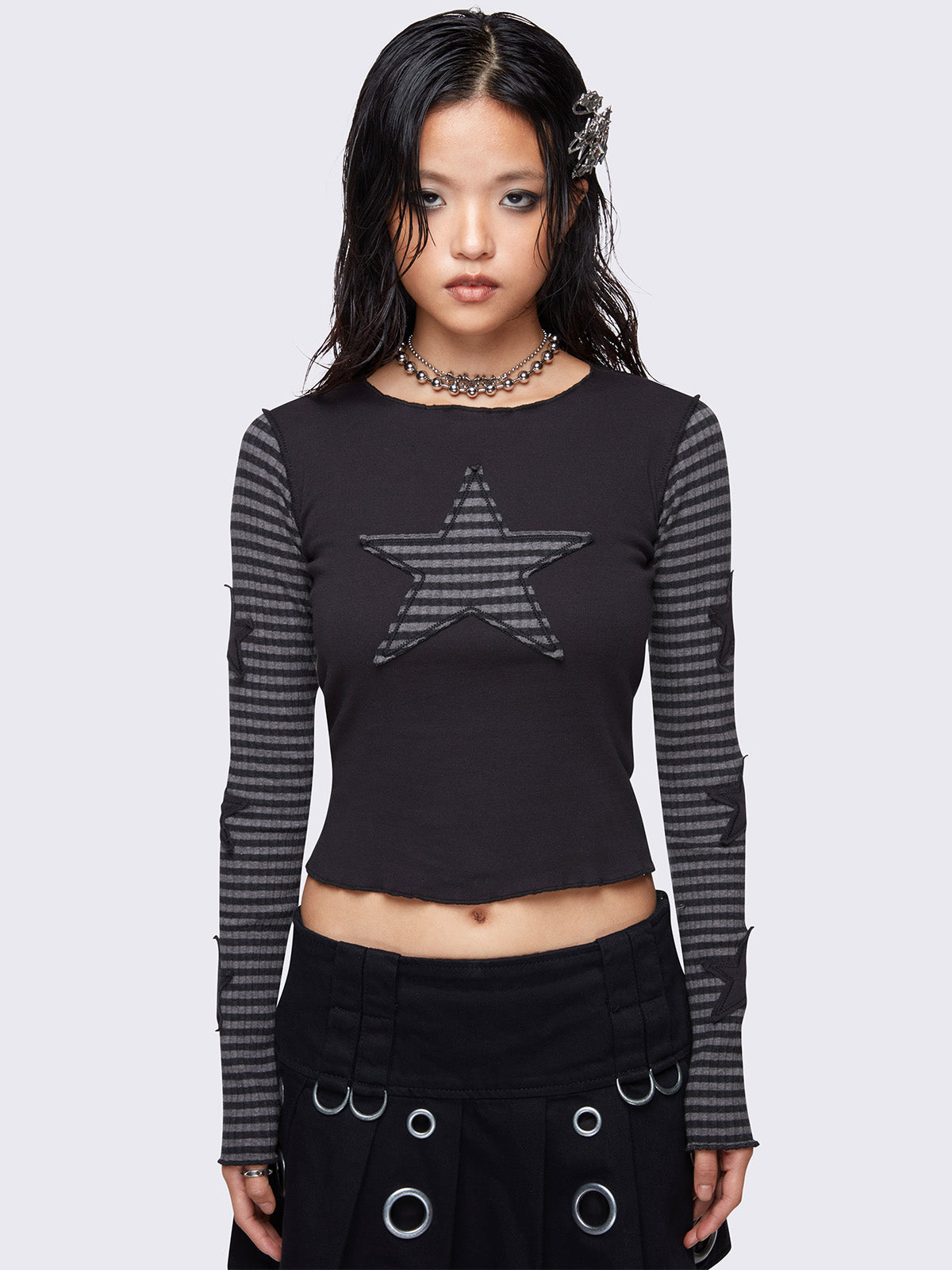 Black long sleeve top with grey striped sleeves and striped star patch on front and black stars on sleeves