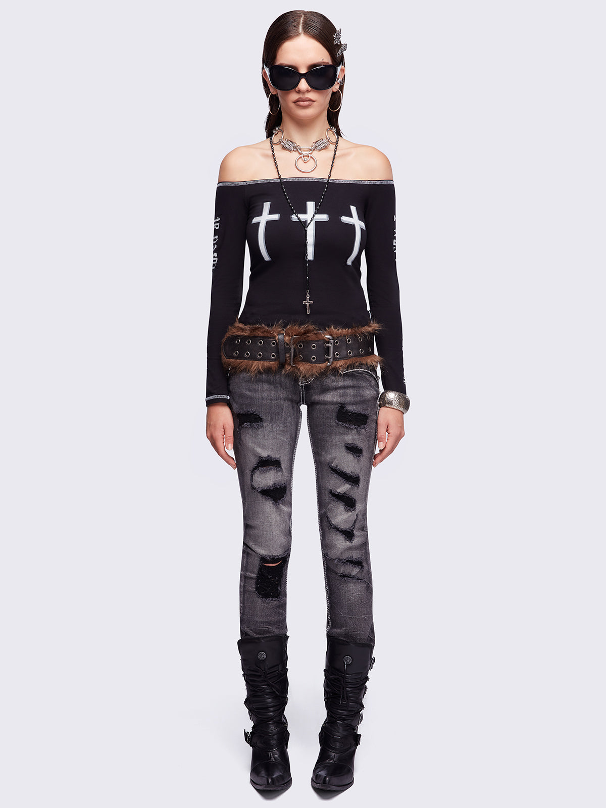 Black washed skinny jeans featuring ripped and stud details, white contrast stitching, embroidered back pocket and raw frayed hems.