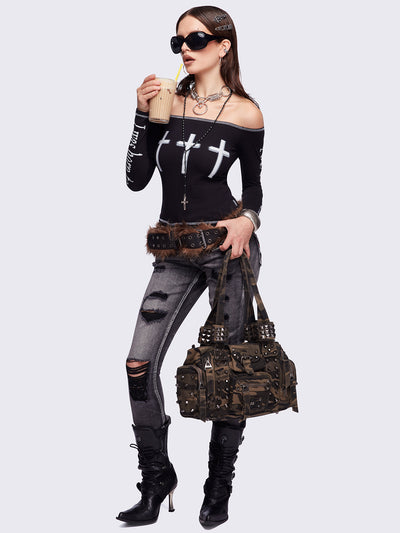 Black washed skinny jeans featuring ripped and stud details, white contrast stitching, embroidered back pocket and raw frayed hems.