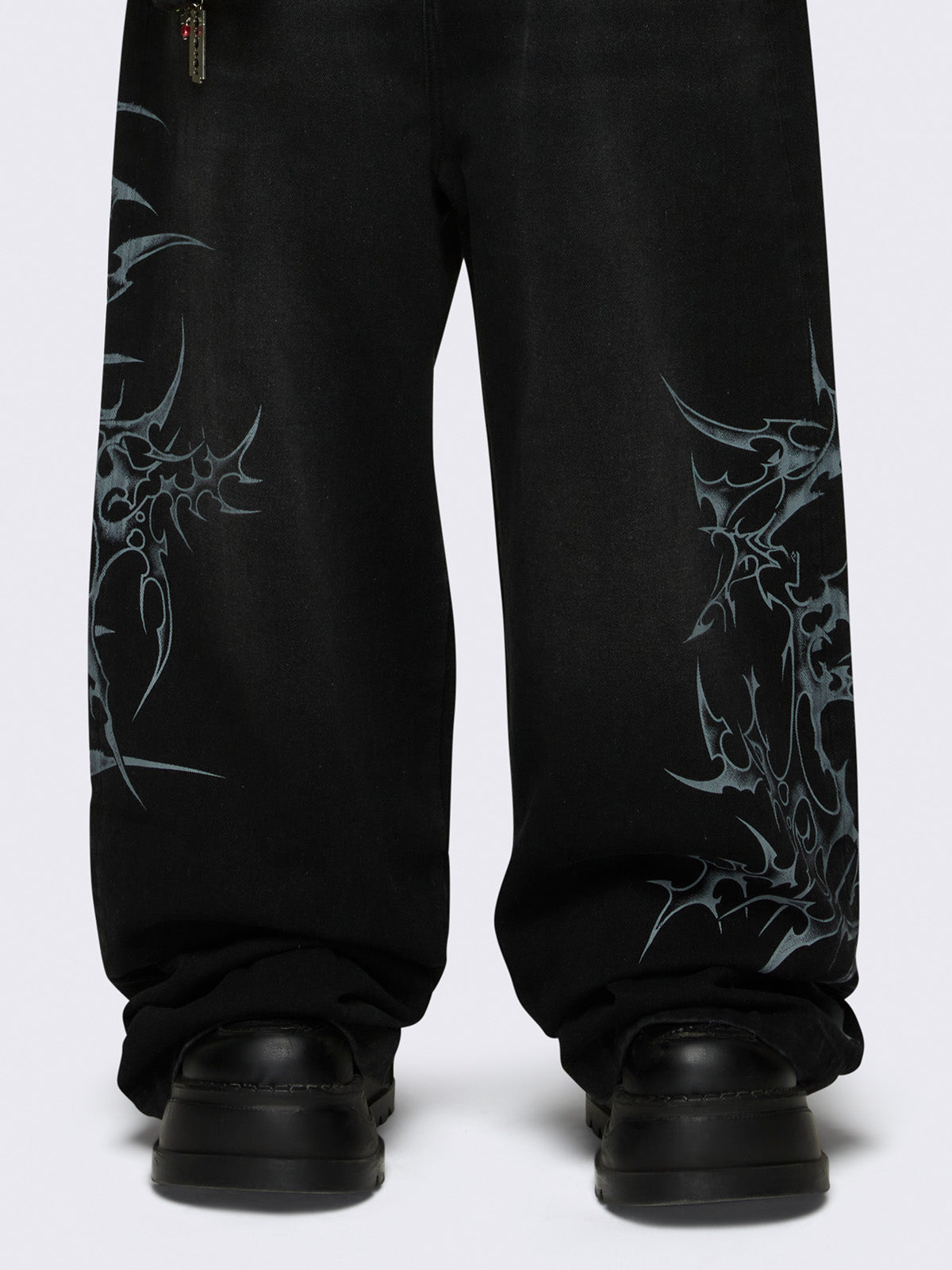 Baggy jeans in black with sigilism graphic print