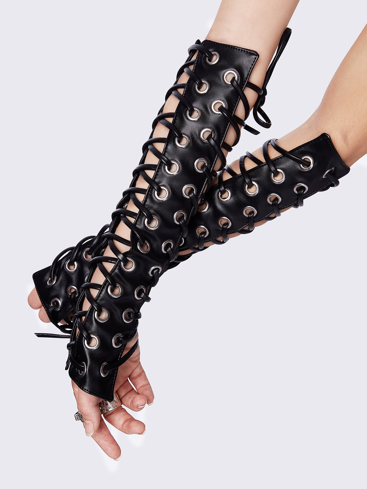 Black faux leather goth arm warmers featuring all over lace up and grommet.