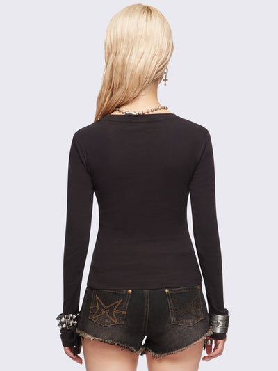 Black long sleeve top featuring a winged dagger and letters graphic print.