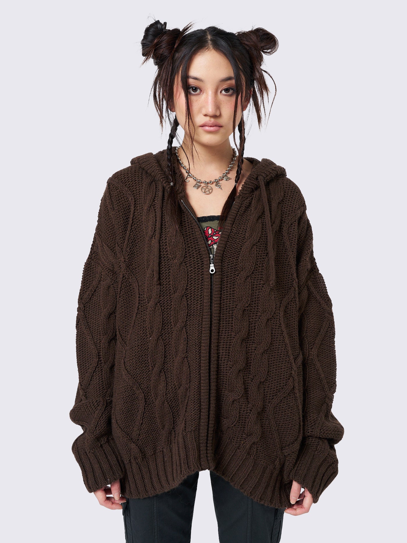 Oversized brown cable knit hooded cardigan with zip fastening and side pockets.