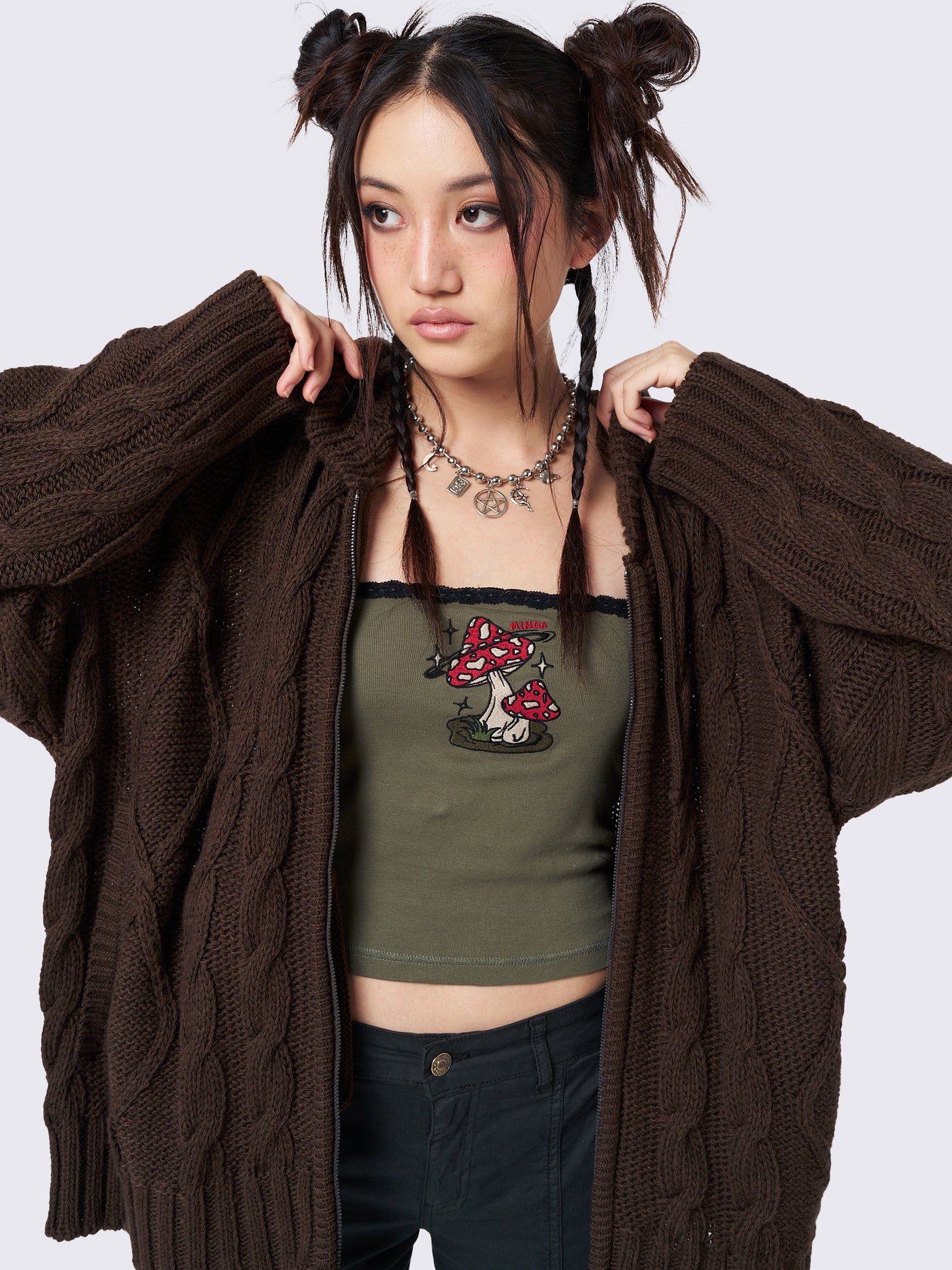 Oversized brown cable knit hooded cardigan with zip fastening and side pockets.