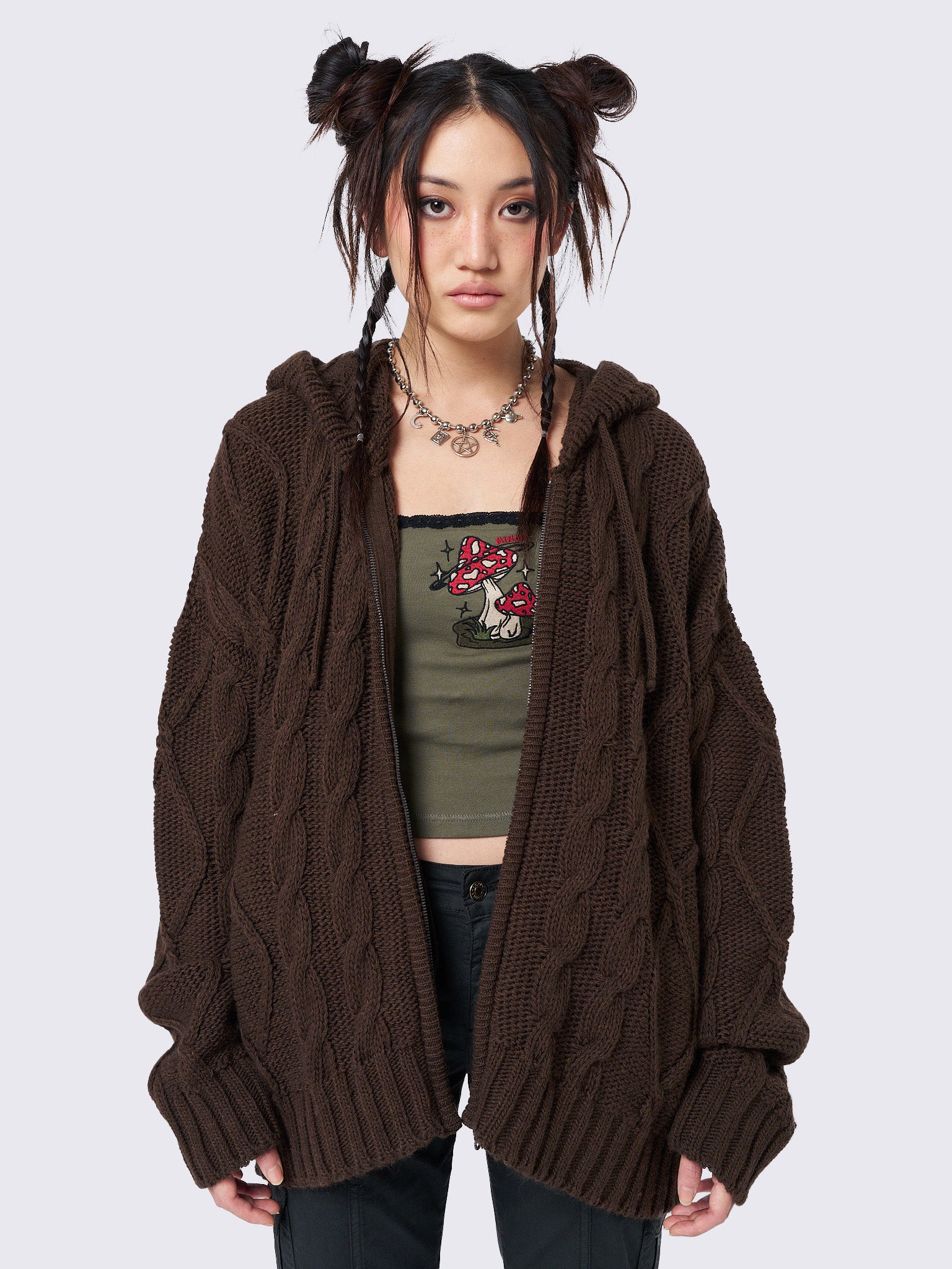 Oversized brown cable knit hooded cardigan with zip fastening and side pockets.