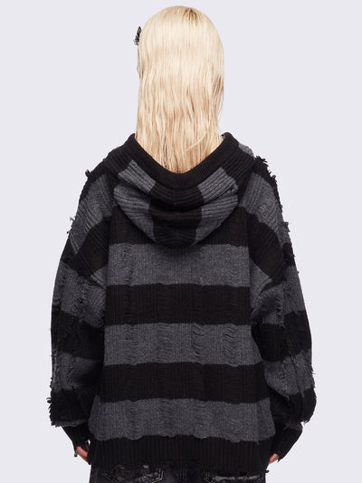 Hooded chunky knit cardigan in black and grey stripes with distressed details.