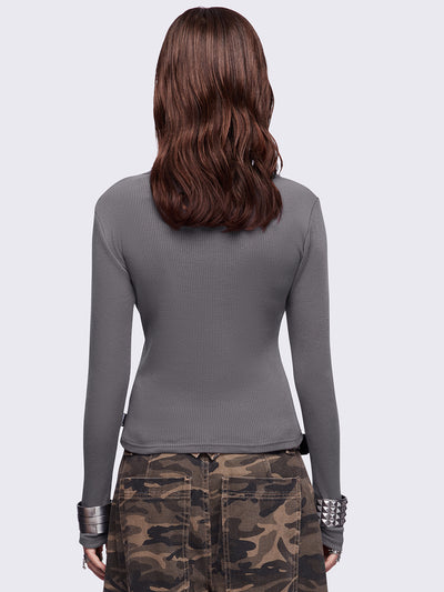 Grey long sleeve top featuring a "Feathers stained with chaos" wings graphic print and v-neck style.