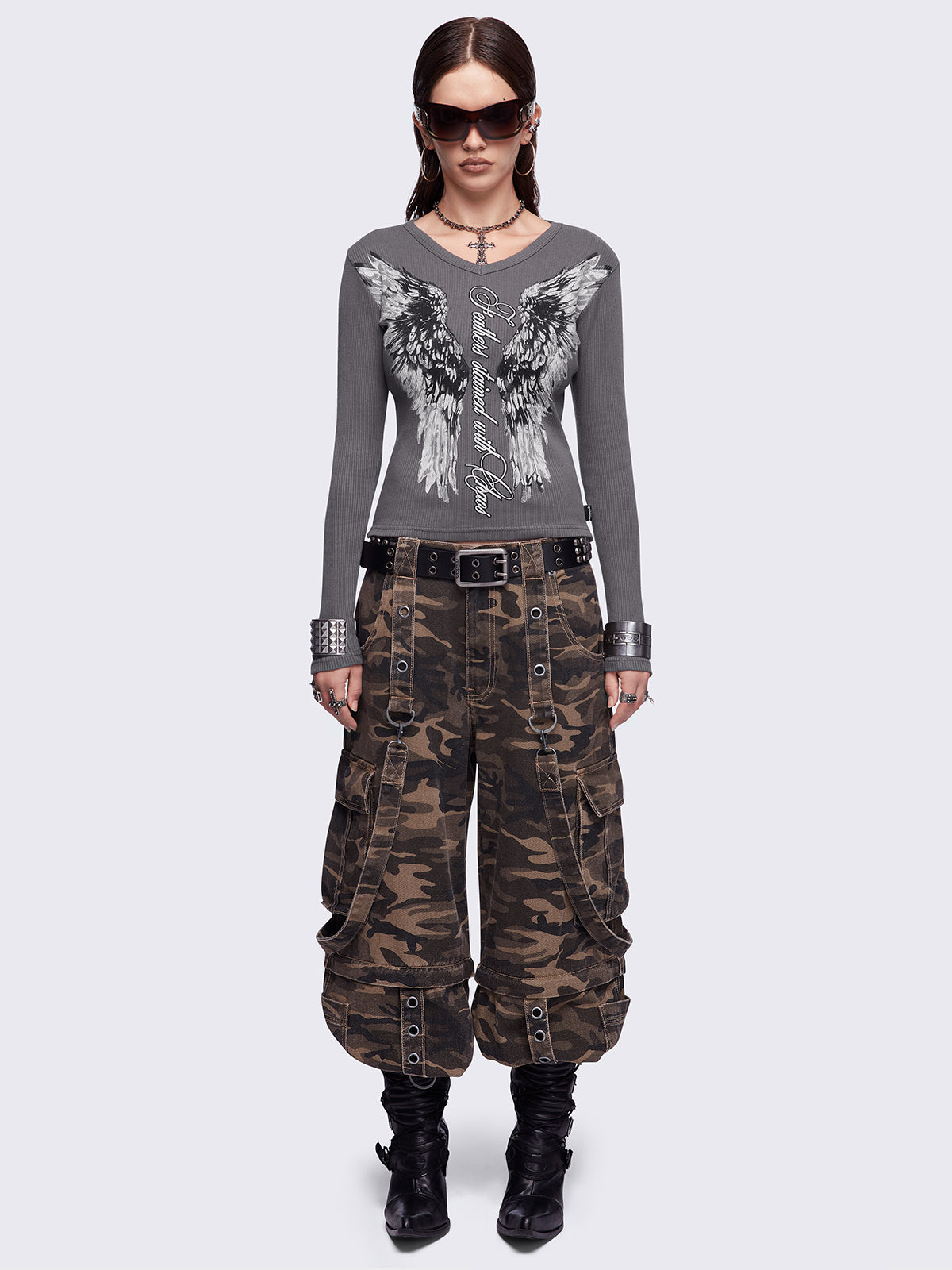 Grey long sleeve top featuring a "Feathers stained with chaos" wings graphic print and v-neck style.