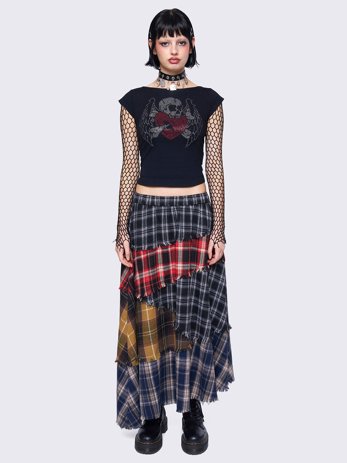 Patchwork tiered maxi skirt with multi-colored plaid panels and frayed trims.