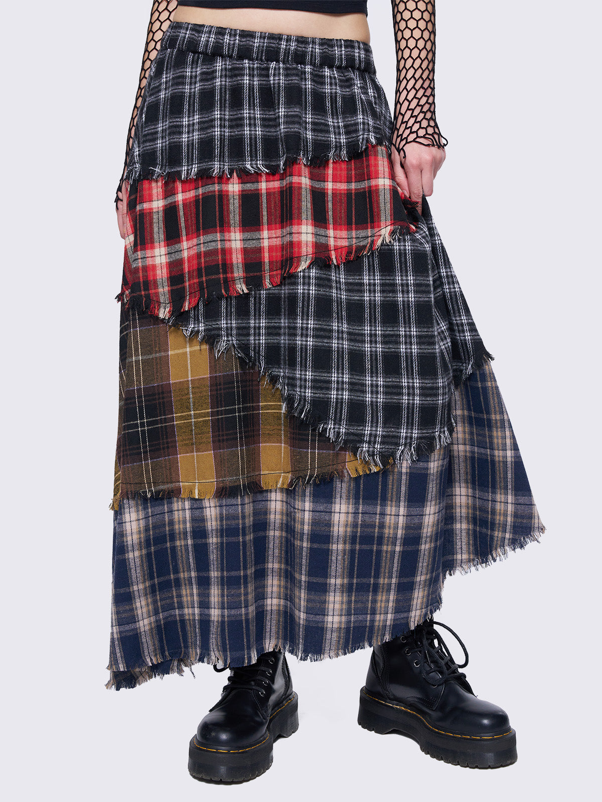 Patchwork tiered maxi skirt with multi-colored plaid panels and frayed trims.