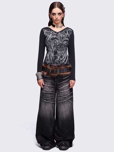Black washed v-neck ribbed top featuring a fleur-de-lis graphic front print and silver stud details.