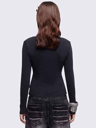Black washed v-neck ribbed top featuring a fleur-de-lis graphic front print and silver stud details.