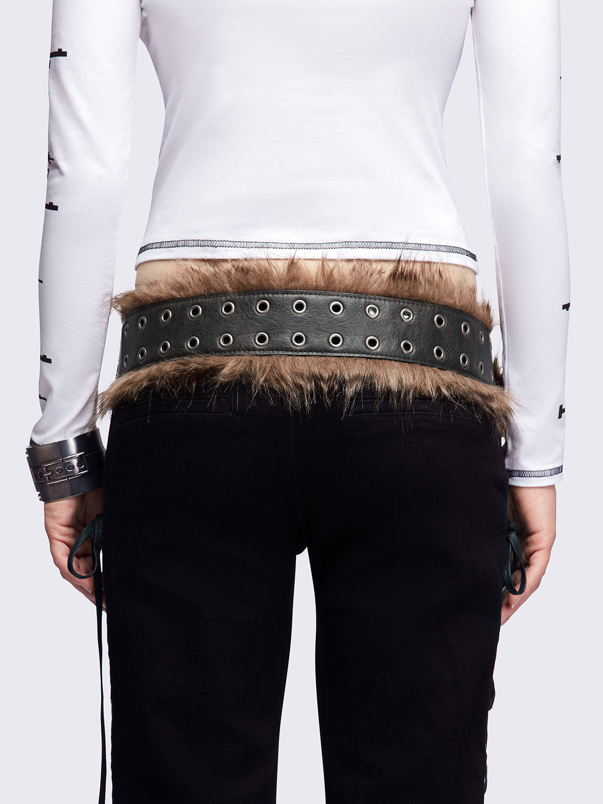 Black double grommet belt featuring brown faux fur trim.
