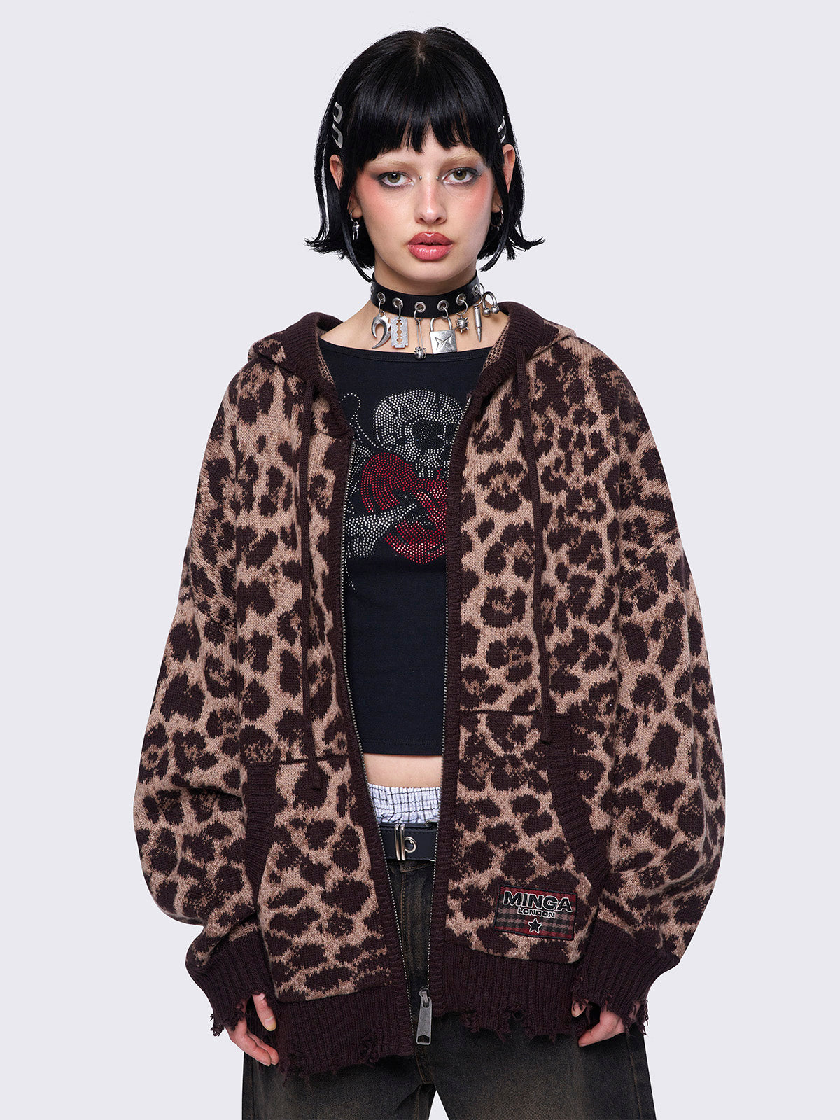 Leopard print knitted zip-up cardigan featuring a hood and distressed ribbed details for a trendy and cozy look