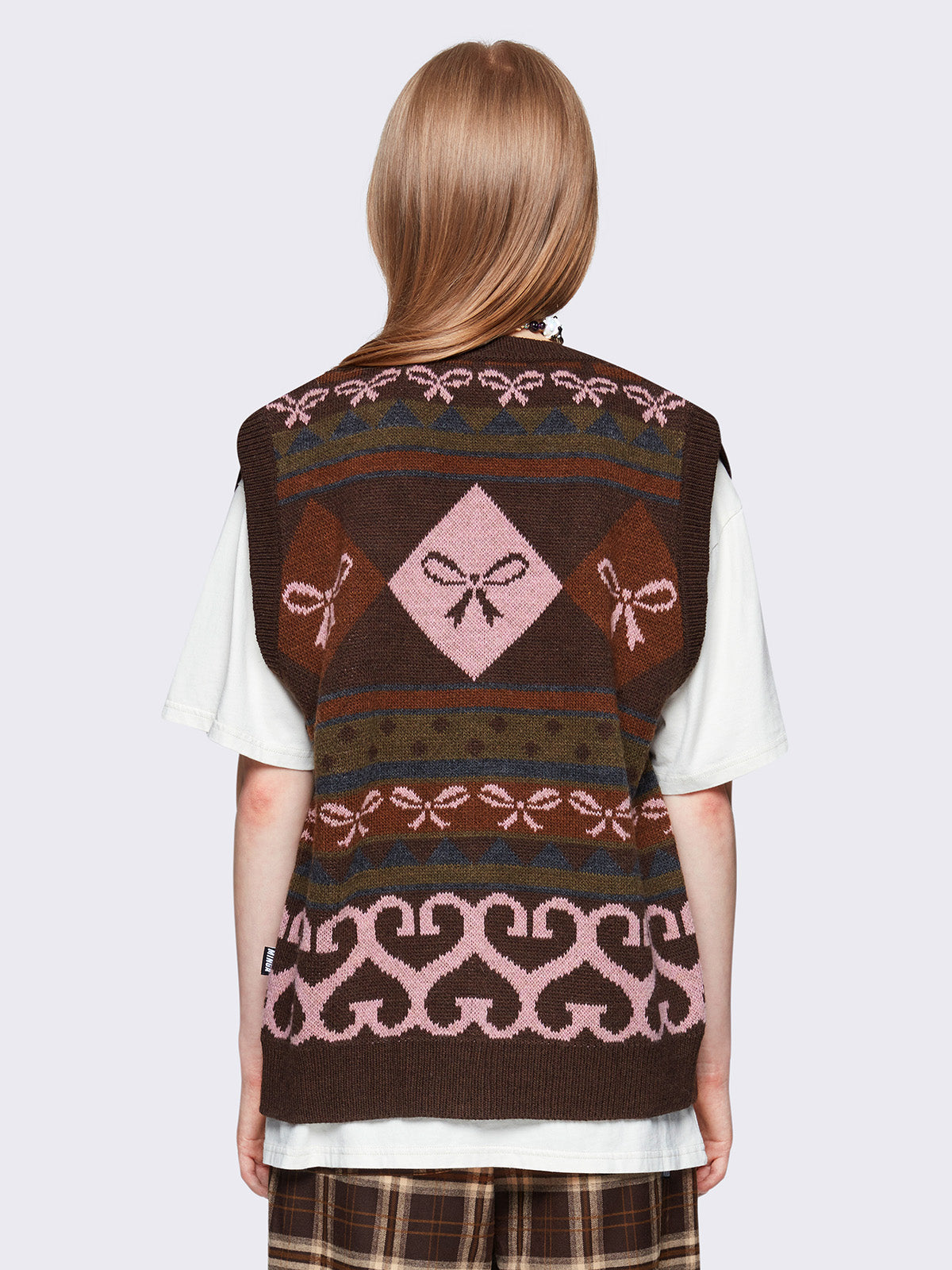 Jacquard knit sweater vest in brown with geometric striped pattern and bows design