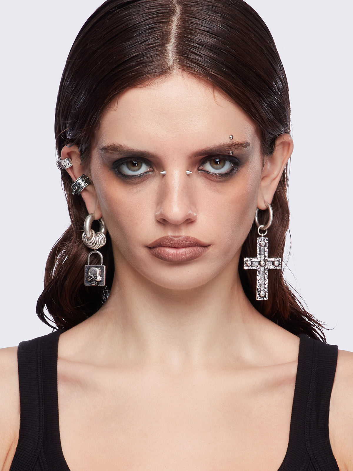 Silver 7pc earring set featuring cross pendants and more styles.