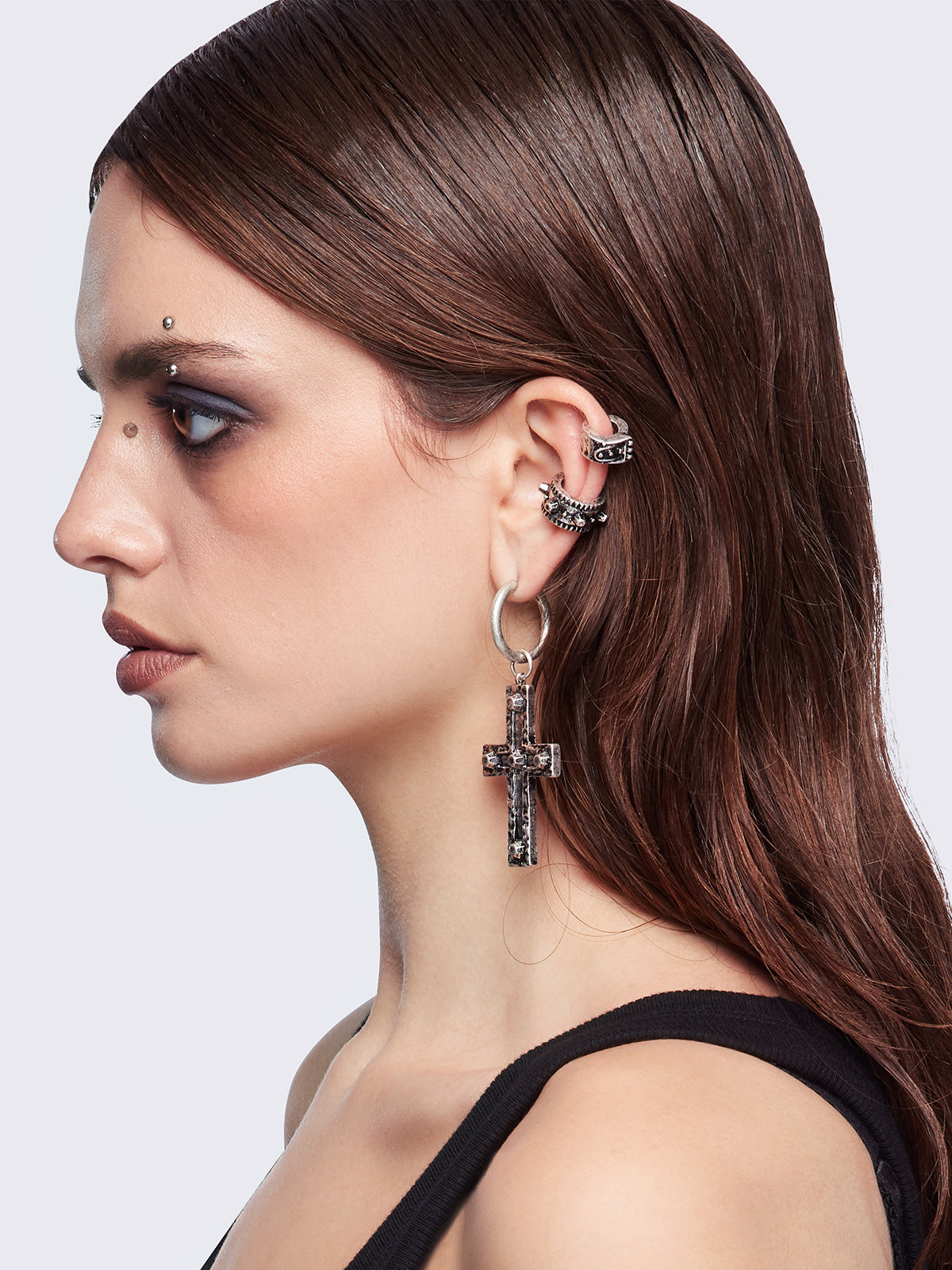 Silver 7pc earring set featuring cross pendants and more styles.