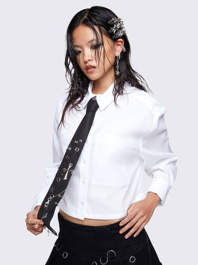 Tie in black with metal safety pins, eyelets and rings and cross, stars charms, key, and bear pendants