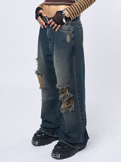 ripped knees baggy jeans in washed blue and loose fit- side view