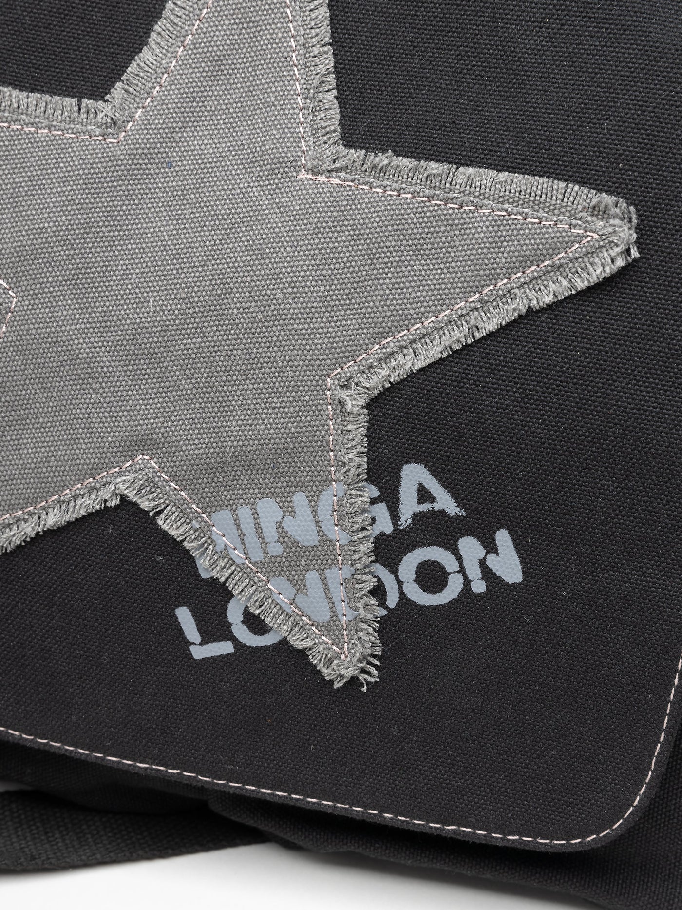 Grunge-inspired Y2K canvas messenger bag in washed black with Minga star front print in grey.