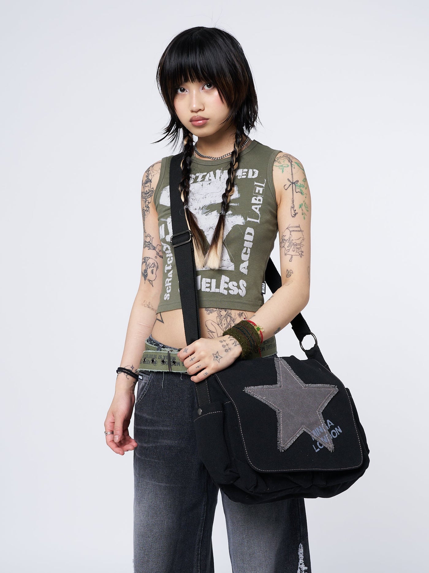 Grunge-inspired Y2K canvas messenger bag in washed black with Minga star front print in grey.