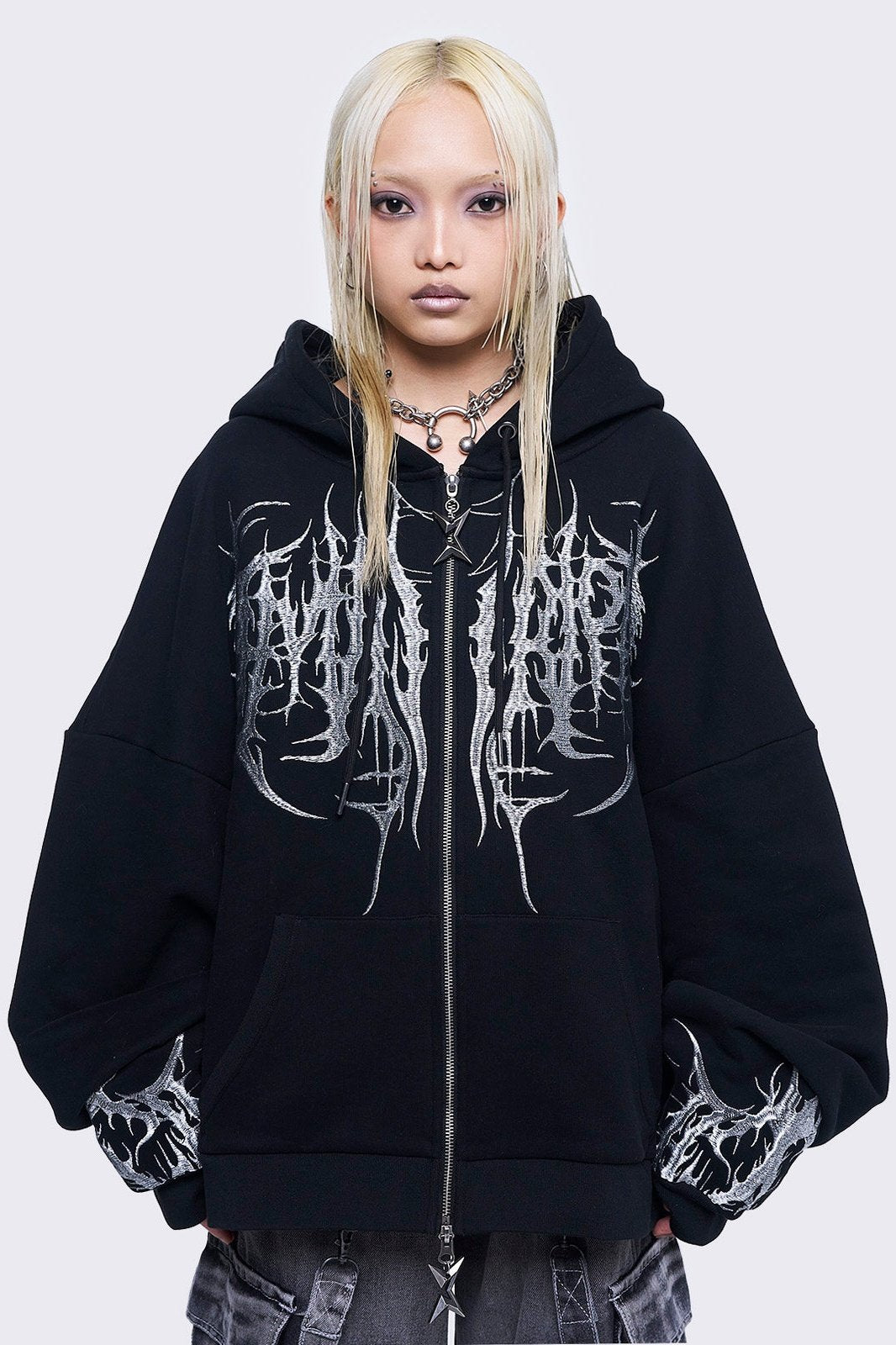Black zip up hoodie jacket featuring a grey sigilism embroidery on front and sleeves and a oversized fit. 